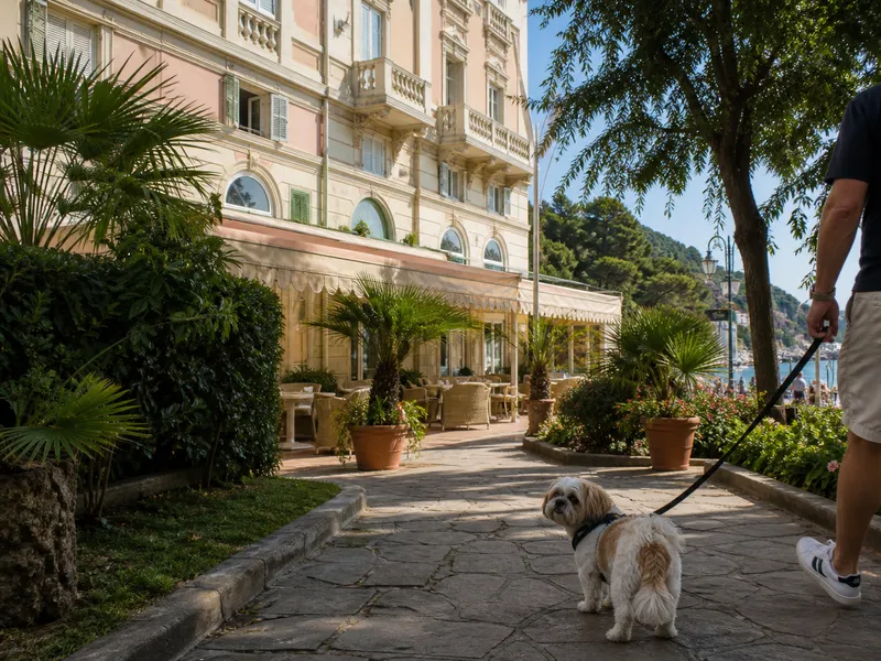 Dog on a lead in the garden entrance of Hotel Giardino al Mare